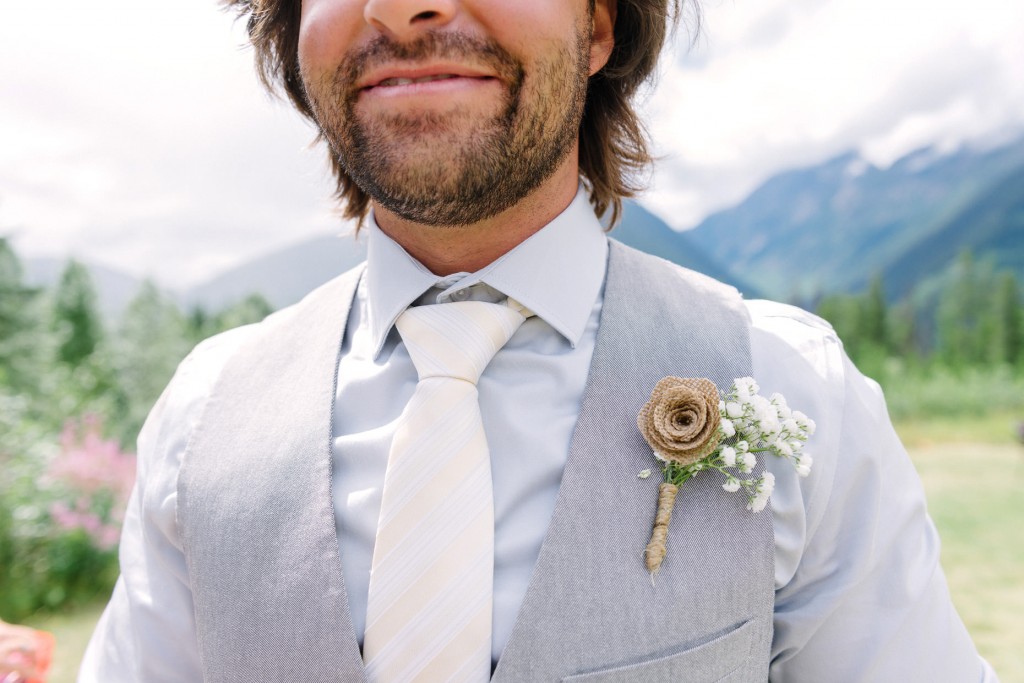 Groom smiling down the aisle at Heather Mountain Lodge Golden BC wedding