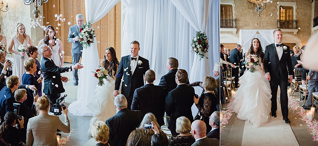 bride and groom walk down the isle to falling roses in Banff 