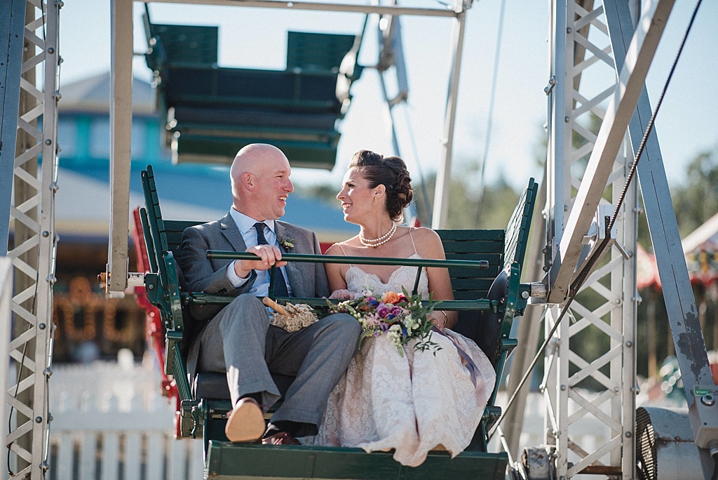 bride-groom-riding-ferris-wheel-after-wedding-ceremony