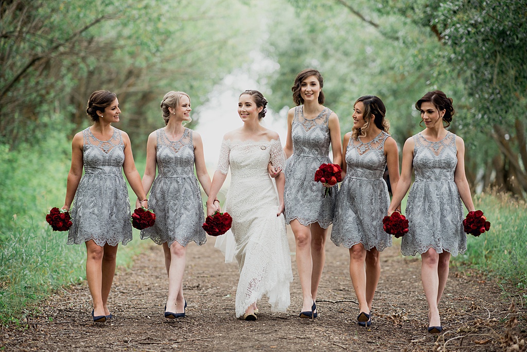 bridal-party-walking-down-path-through-forest