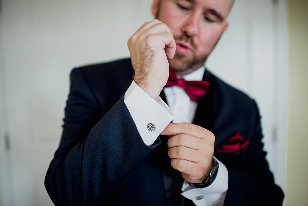 groom-doing-up-cufflinks-on-sleeve