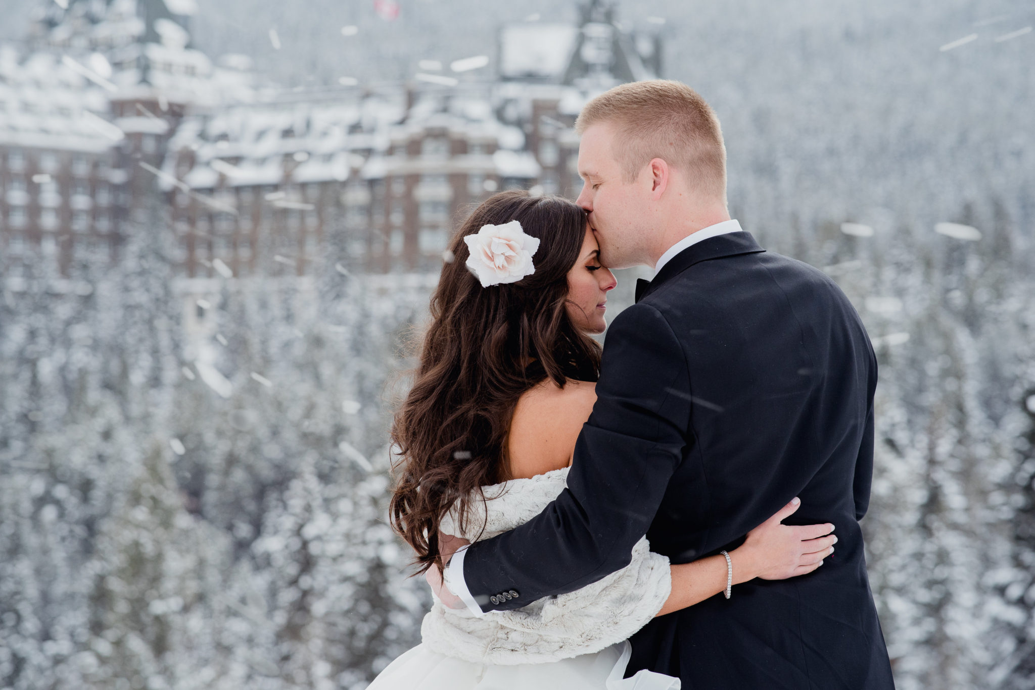 Winter Wedding at the Fairmont Banff Spring couple kissing in the snow