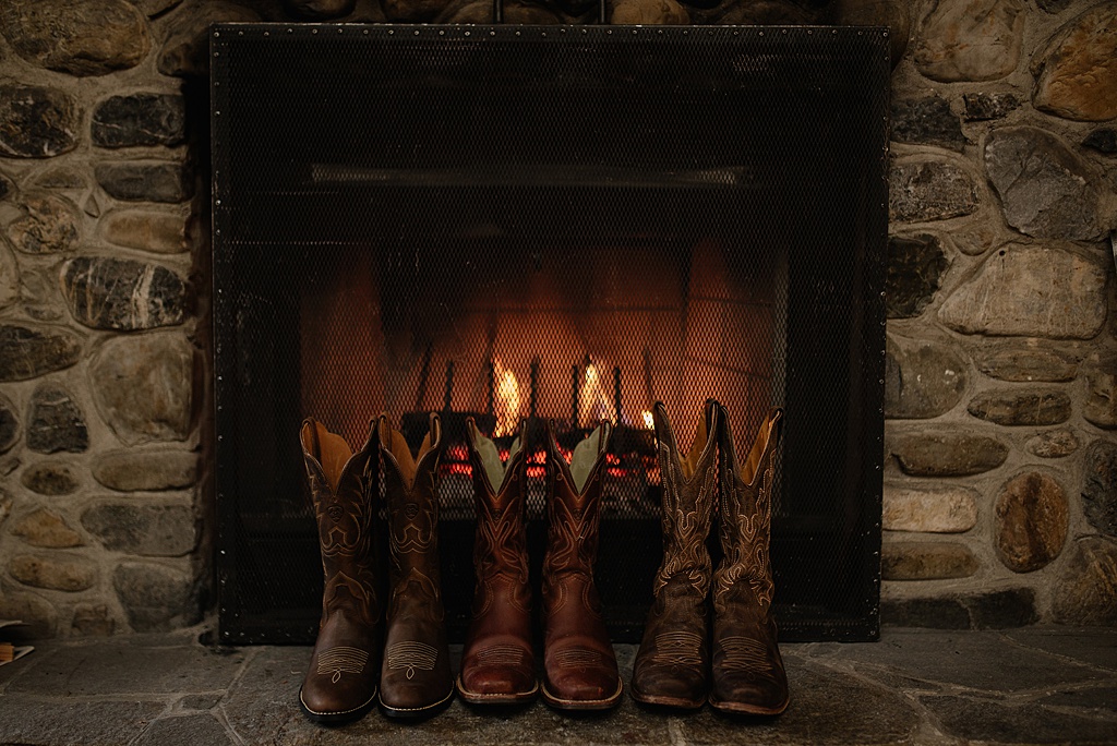 cowboy-boots-lined-up-in-front-of-fireplace